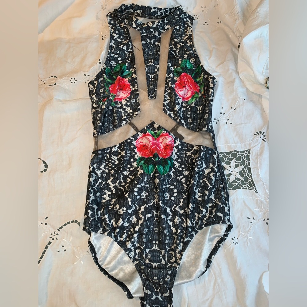 Printed body suit. Cut out to show cleavage.